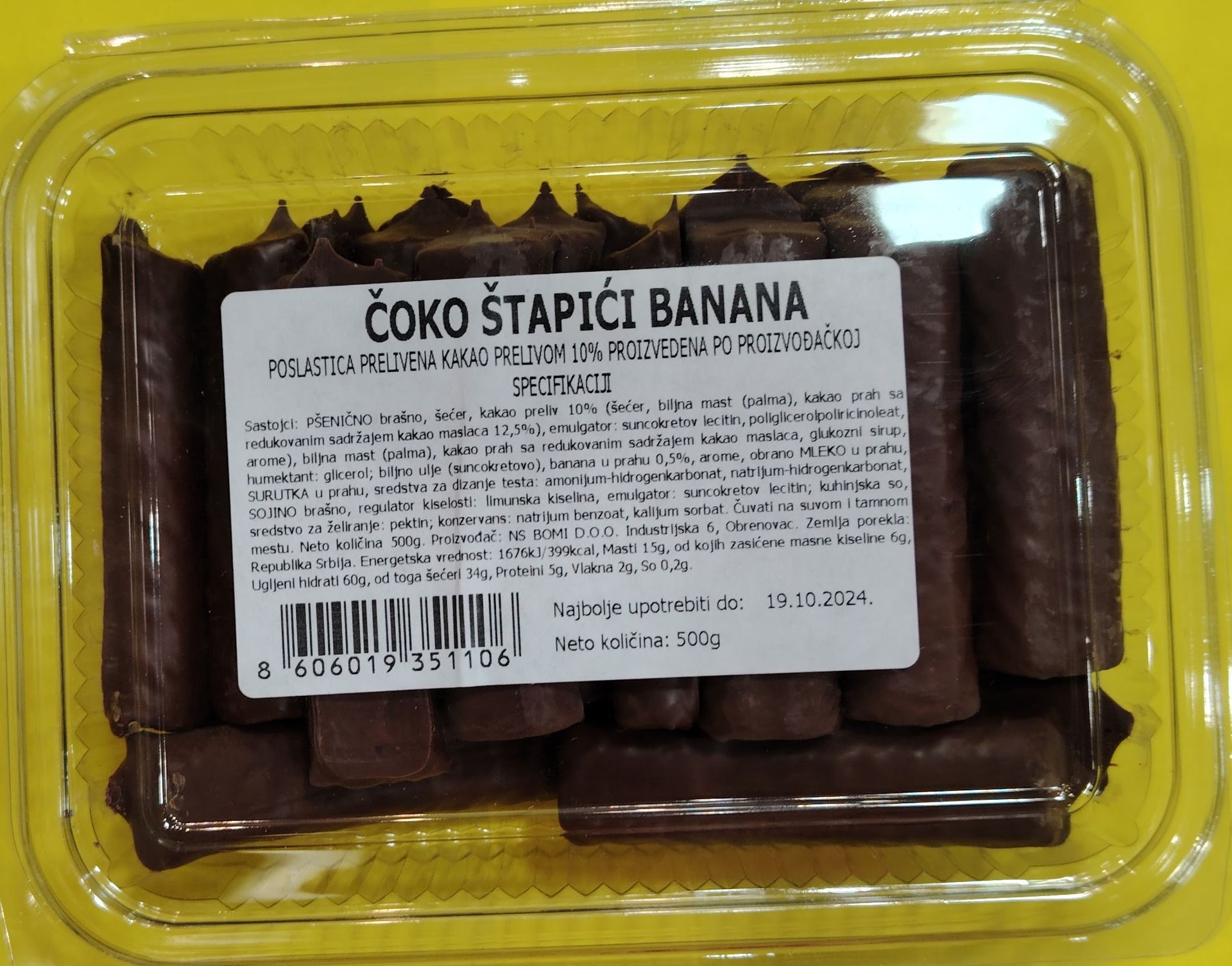 Package of chocolate-covered banana sticks with a label in a foreign language describing ingredients and nutritional information.